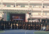 Ground Zero Institute of cadets and instructors posing outdoors on a sports court with their building in the background