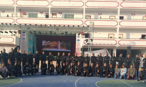 Ground Zero Institute of cadets and instructors posing outdoors on a sports court with their building in the background