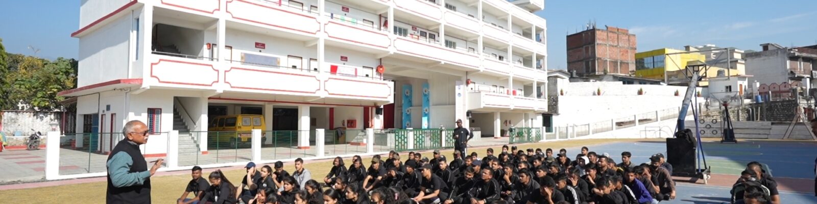 A group of students, mostly dressed in black uniforms